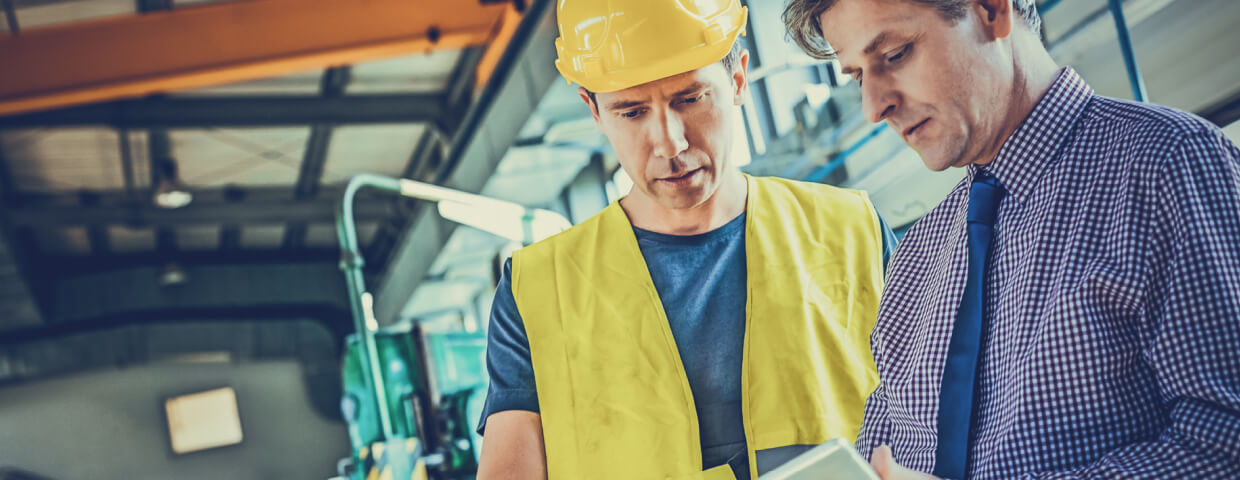 Two men reviewing documents at warehouse