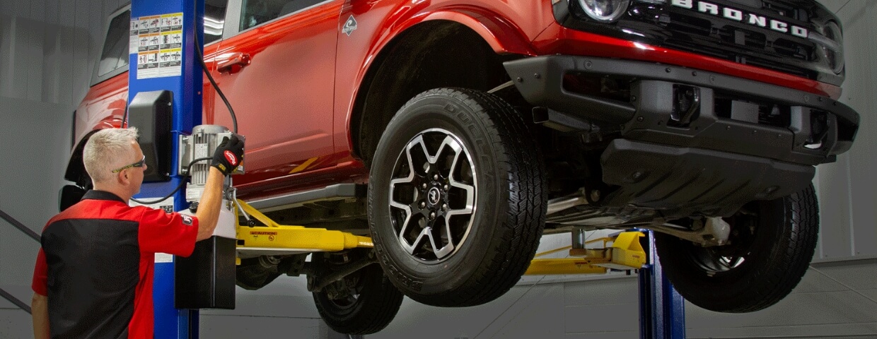 Man working on lifted truck