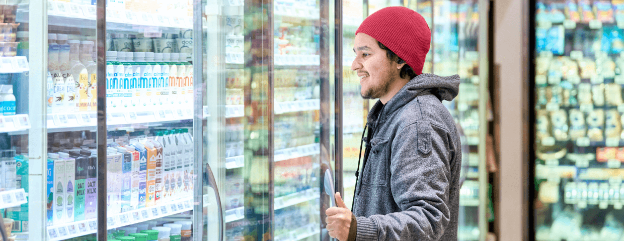 Man browsing case of groceries