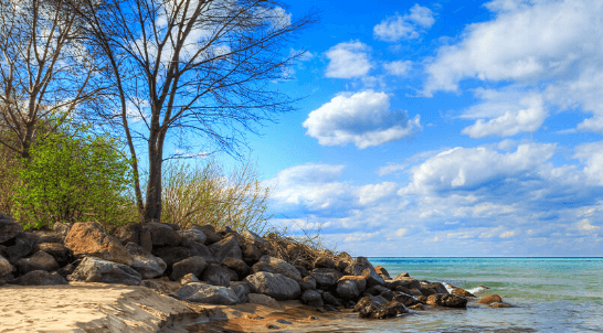 View of water's edge with cloudy sky