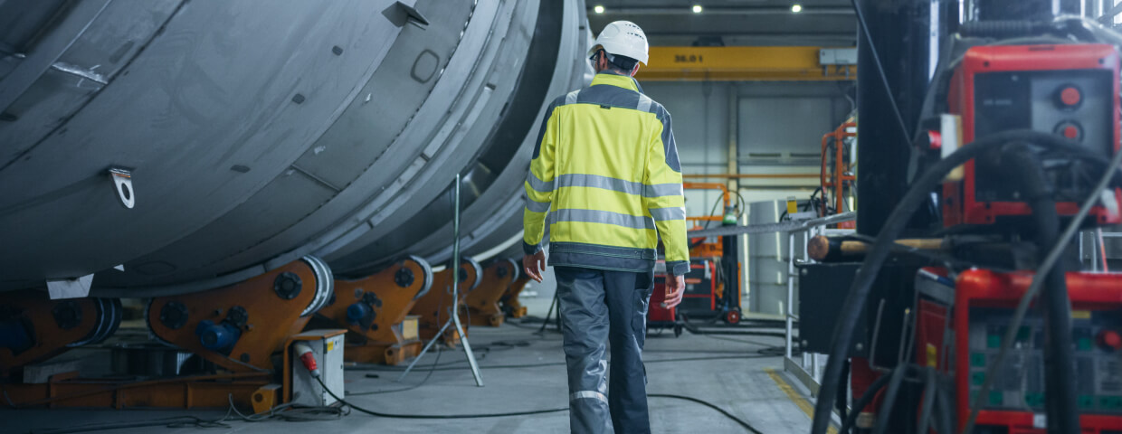 Man walking through industrial warehouse