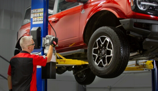 Man working on lifted truck